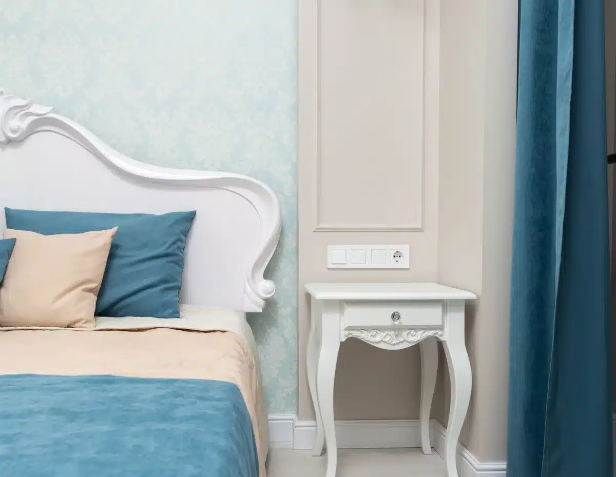 Compact portable air conditioner on nightstand in bright bedroom