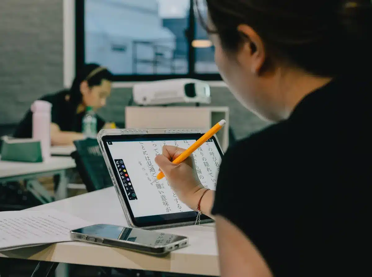 Student using a tablet for interactive learning and note-taking
