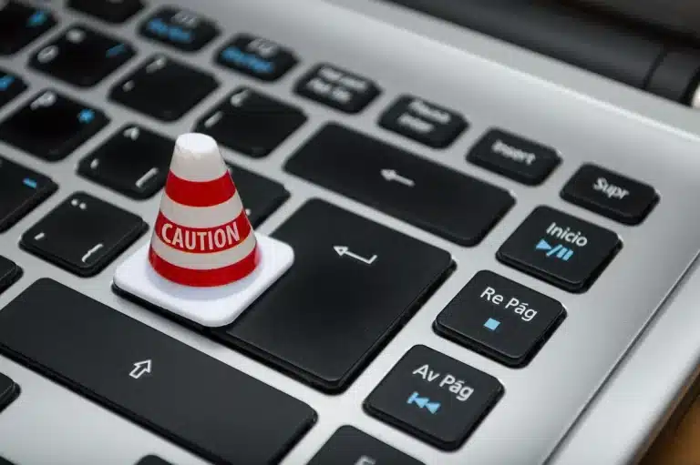 Laptop screen showing a security update notification with a user's hand near the update button