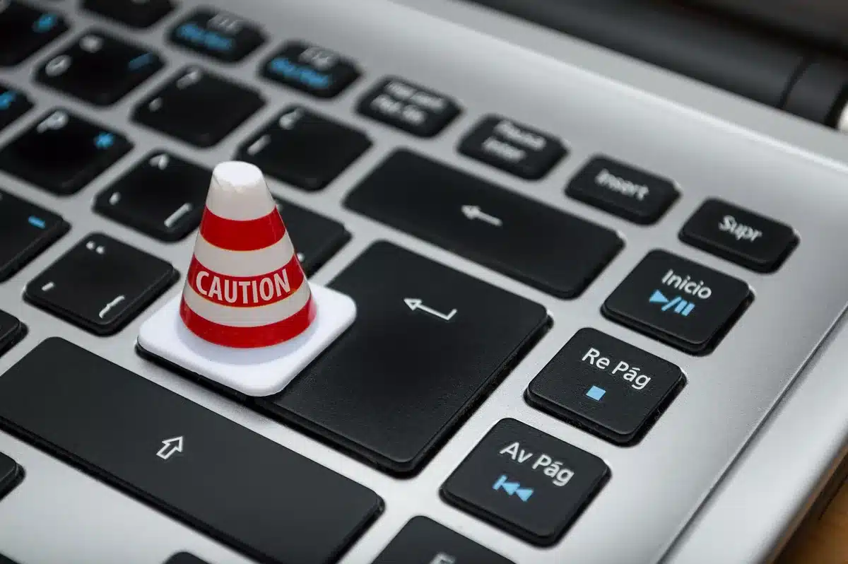 Laptop screen showing a security update notification with a user's hand near the update button