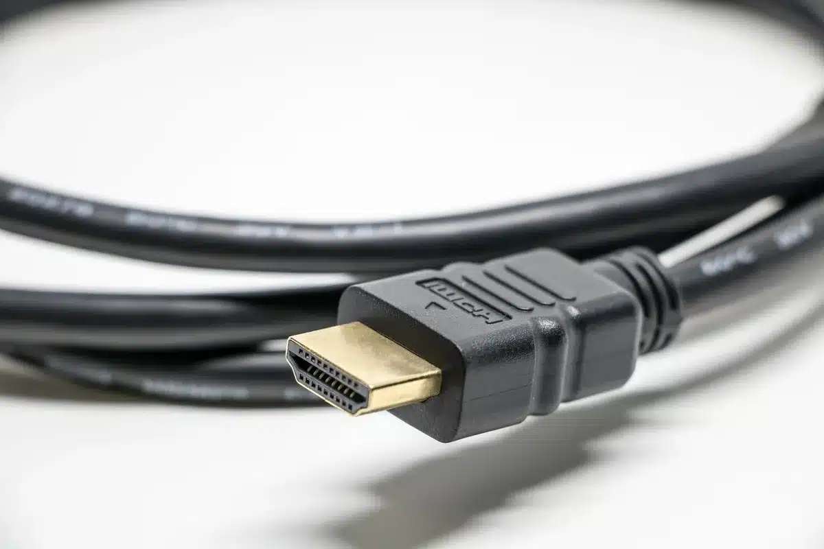 Close-up of TV rear panel showing multiple HDMI input ports and audio connection cables