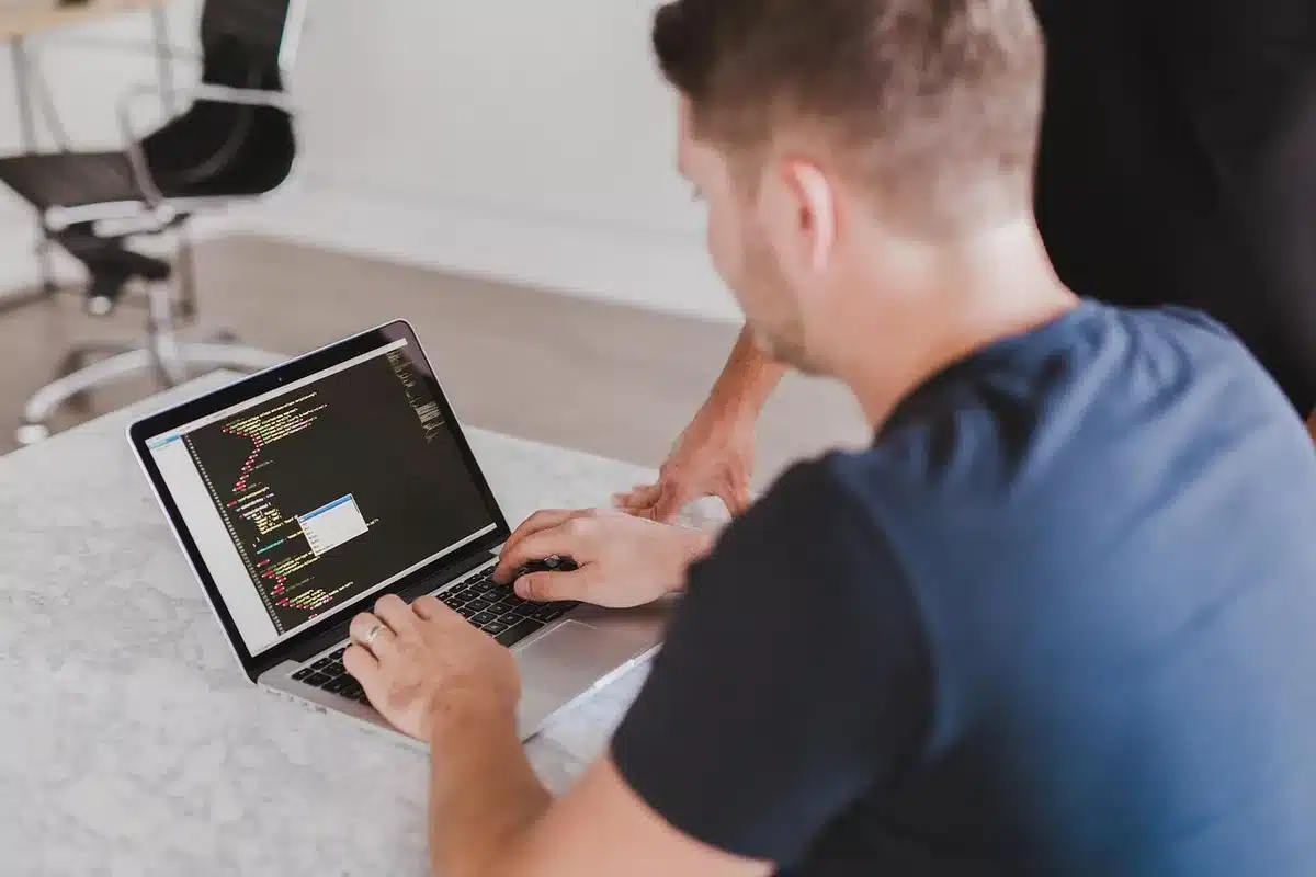 Person working at desk with creative tools and chat interface integrated on screen