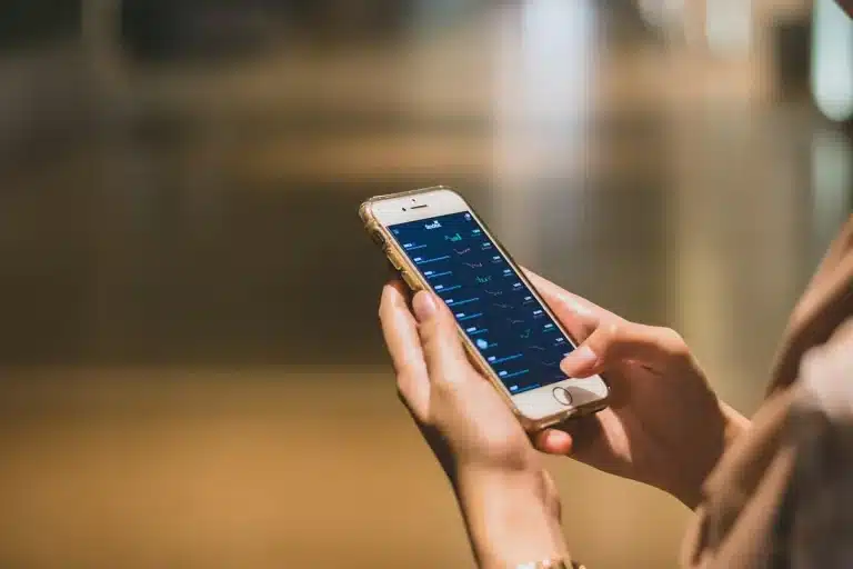 Smartphone showing football league standings and live match updates on a sports tracking app