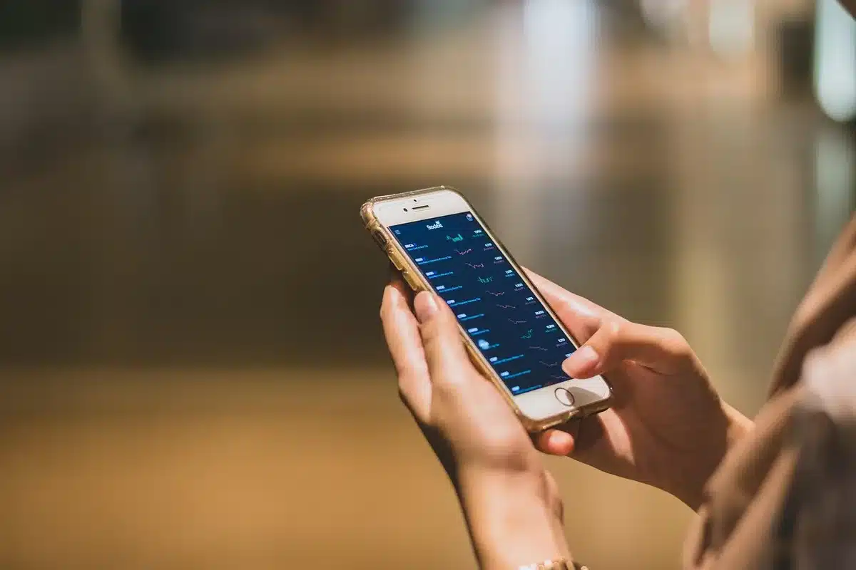 Smartphone showing football league standings and live match updates on a sports tracking app