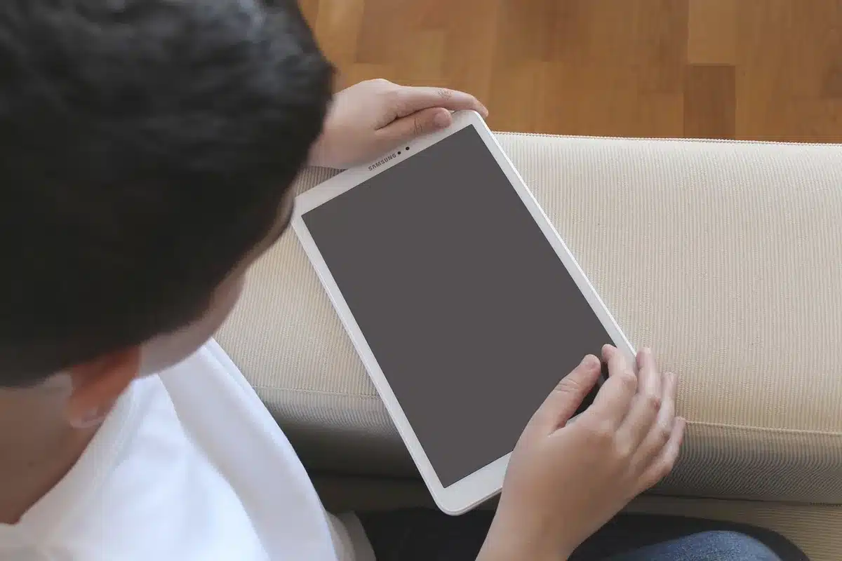 Child-sized stylus next to tablet with drawing app on screen