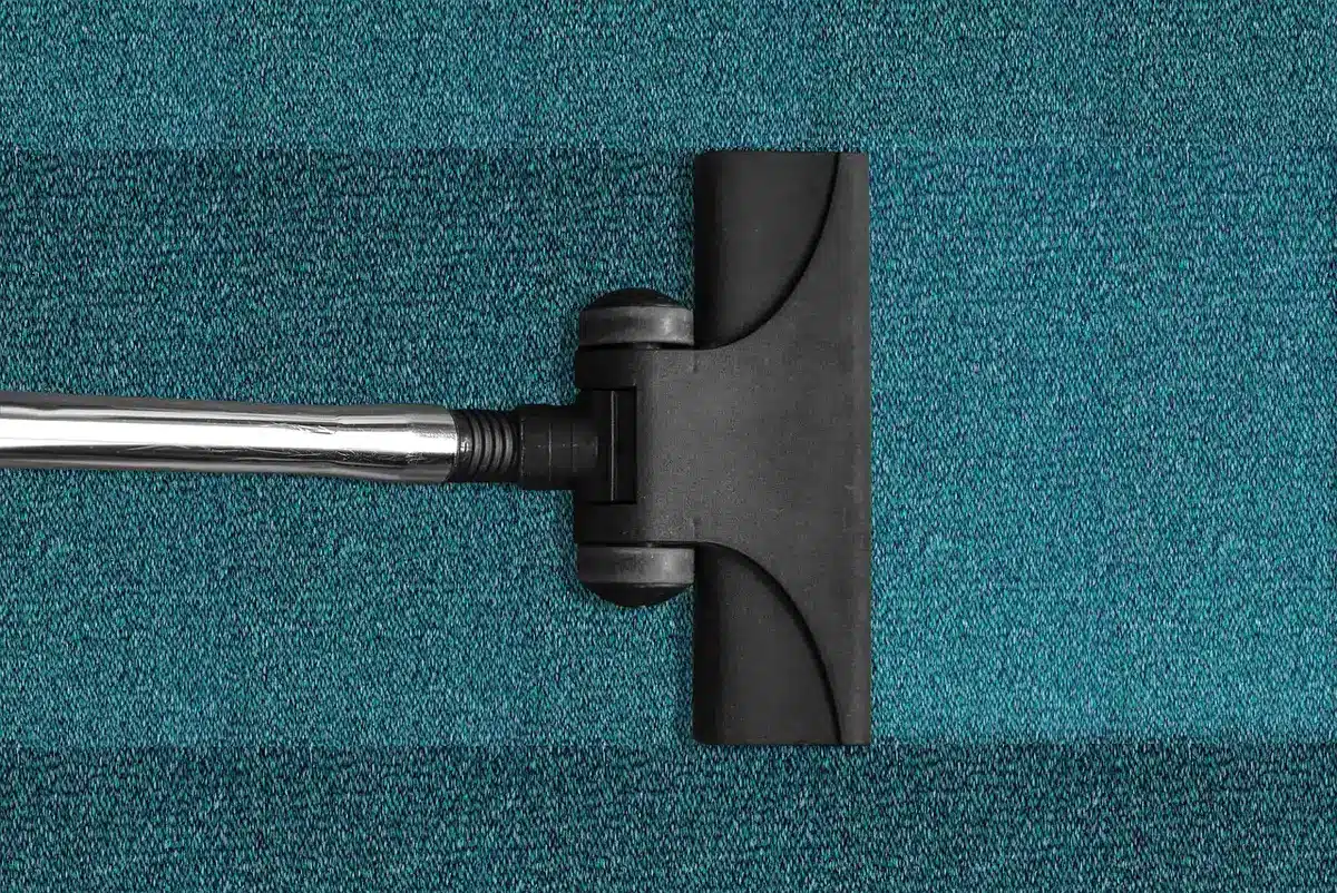 Robotic vacuum with extended roller mop cleaning dirt from hardwood floor
