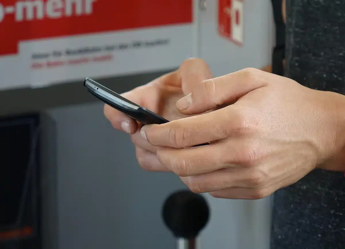 Close-up of an external small screen showing app icons and widgets