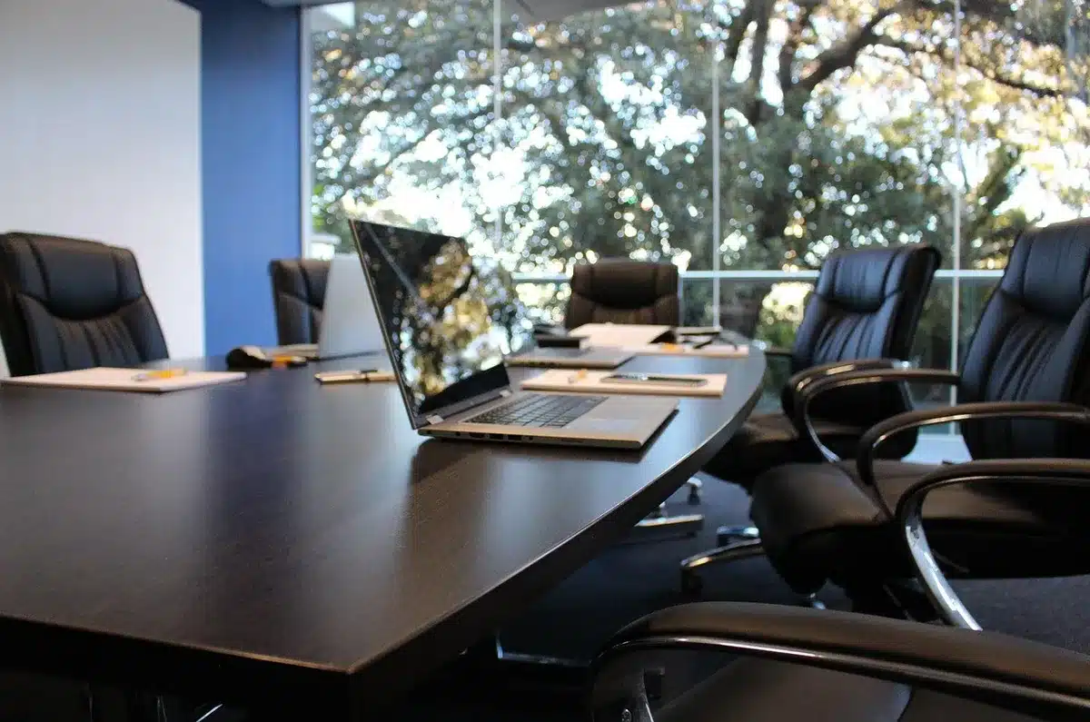 Office table with laptop and printed compensation documents
