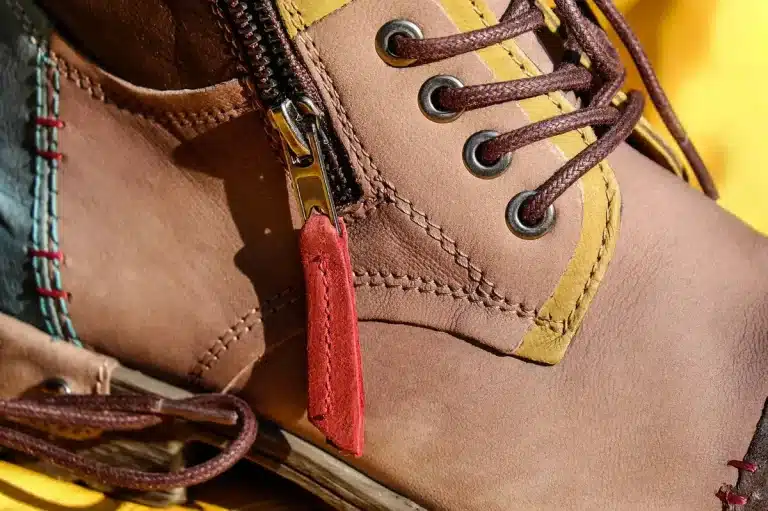 Smartwatch on a wooden desk next to a running shoe and folded map in daylight