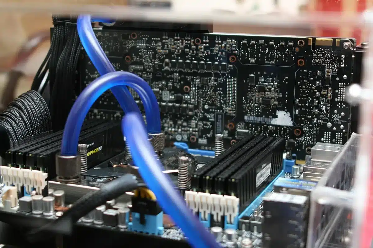 Motherboard on rails being slid out of a compact mini-PC chassis for upgrades