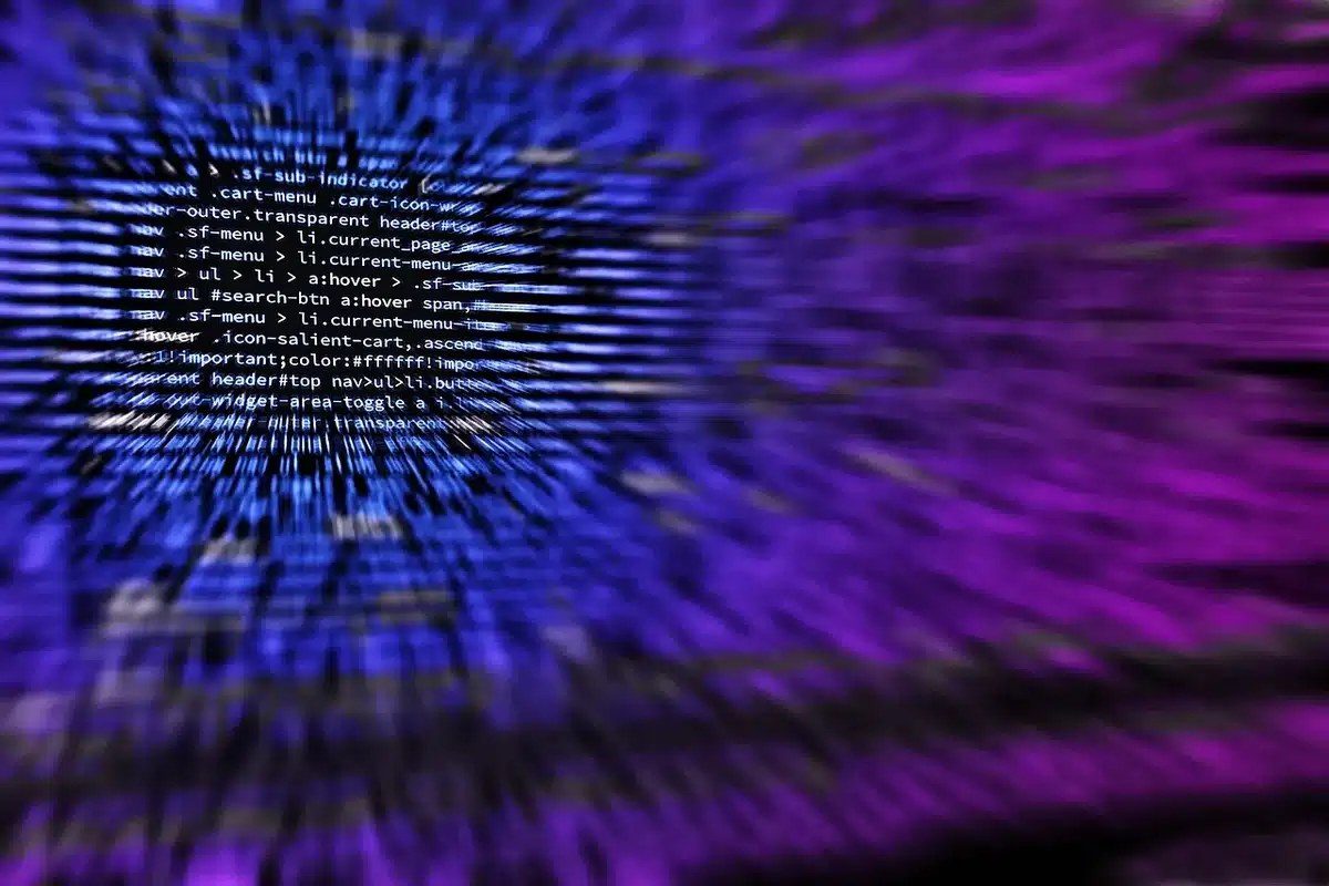 User invoking an AI code assistant from a browser on a laptop in daylight