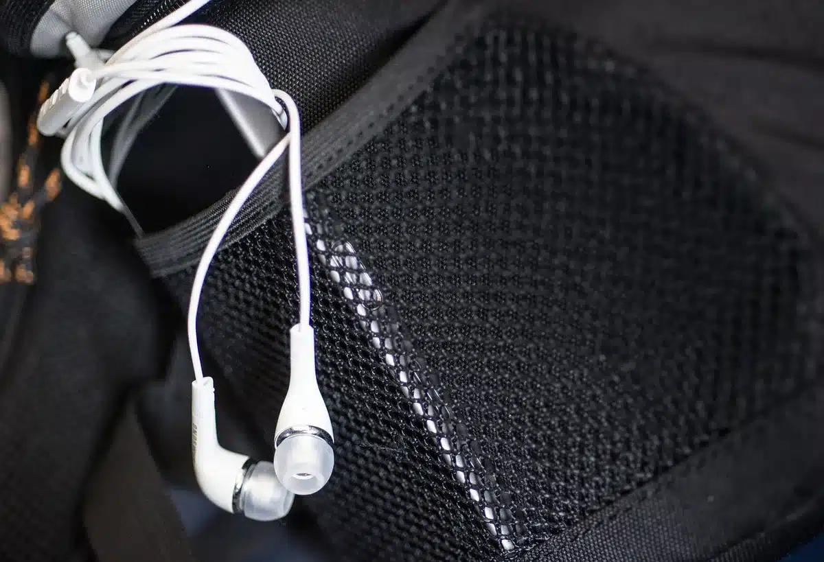 Two pairs of earbuds on a table suggesting comparison of noise cancellation