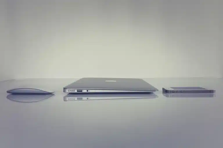 Smartphone on a sunlit table with a notebook and pen, hands tapping the screen