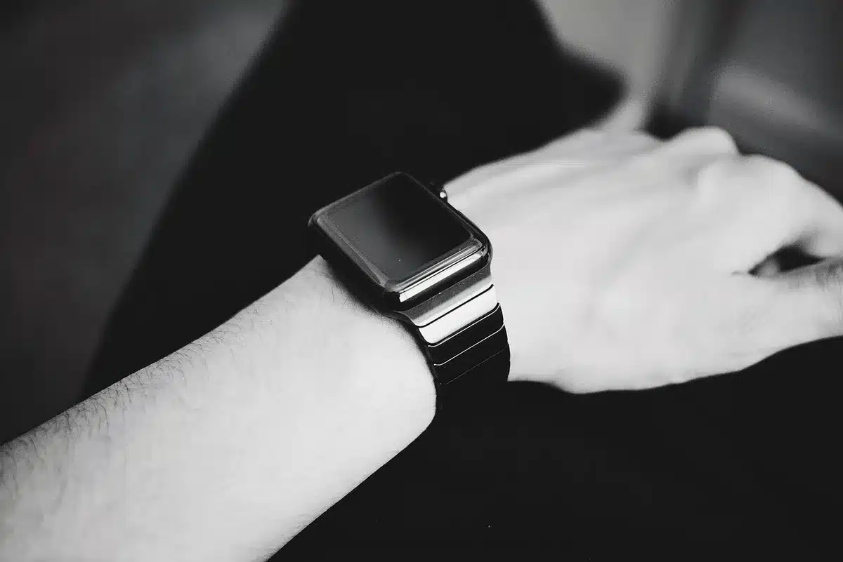 Close-up of a smartwatch showing a bright AMOLED display in daylight