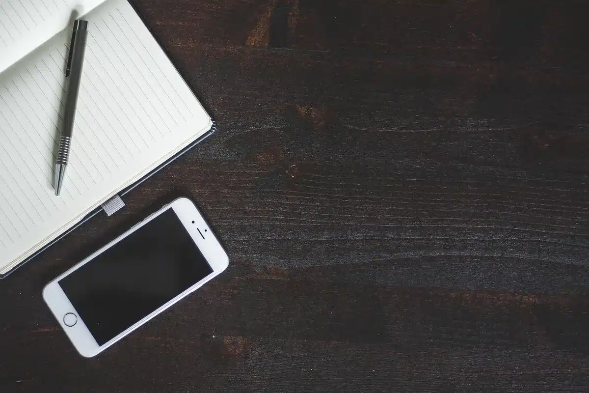 Smartphone open showing two apps side by side on a desk