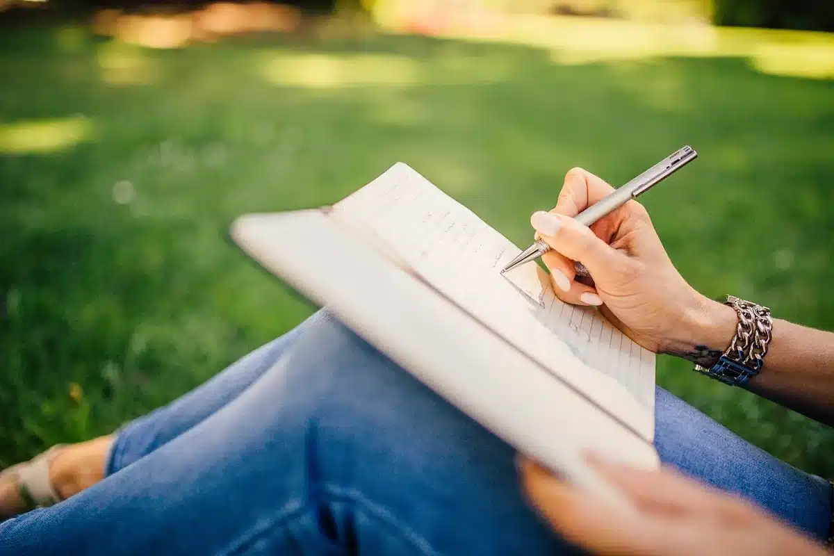 Hand using a stylus on a large foldable screen with notes