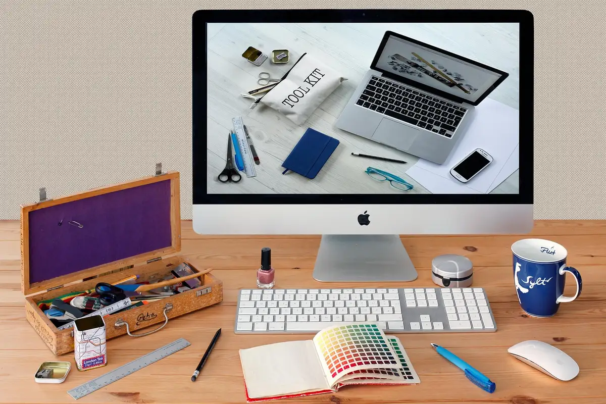 Designer receiving one-to-one coaching beside a laptop in daylight