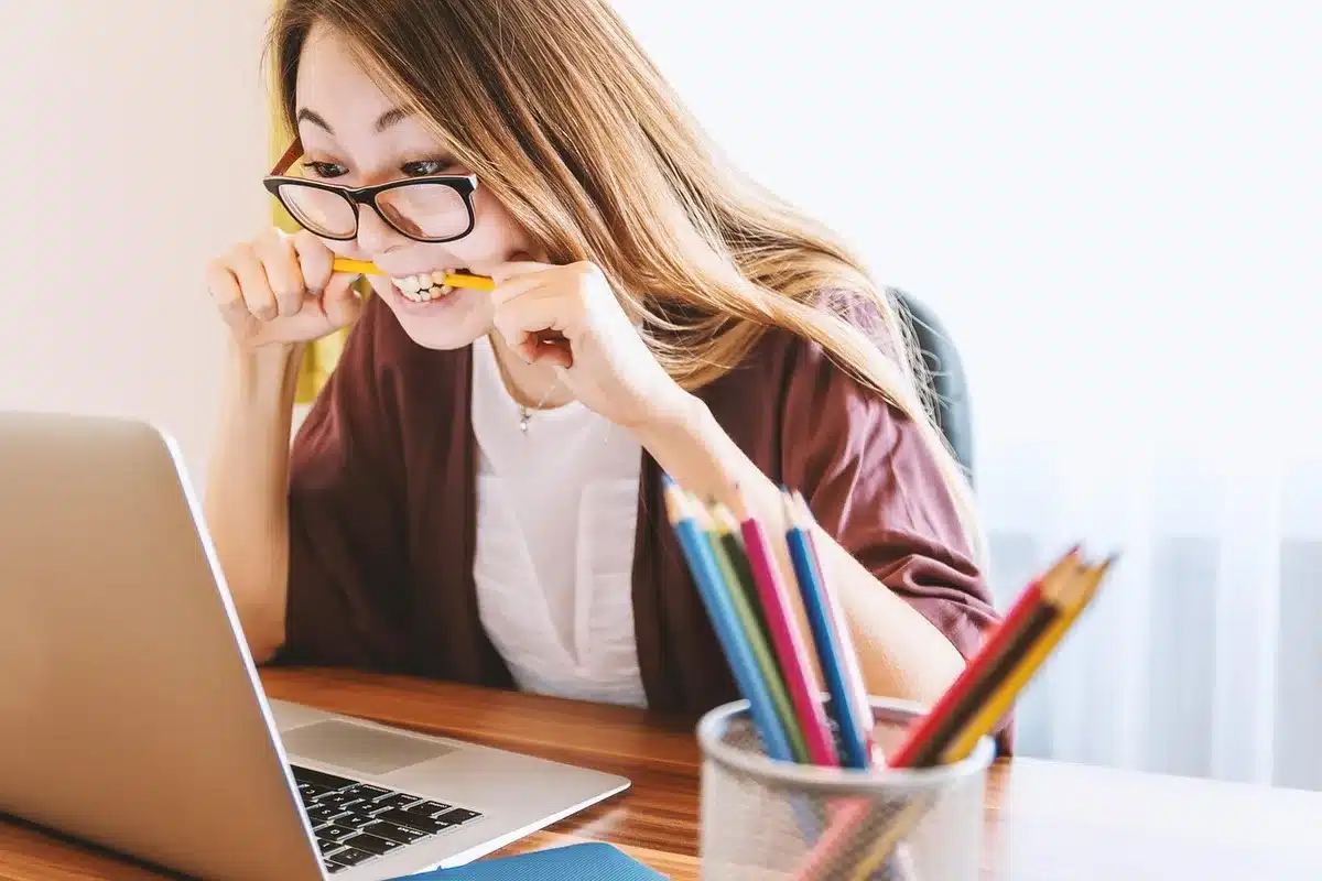 Adolescents en journée regardant un ordinateur portable et prenant des notes
